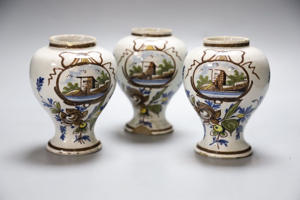 A set of three 19th century Dutch delft baluster jars, painted in colours, 14cm